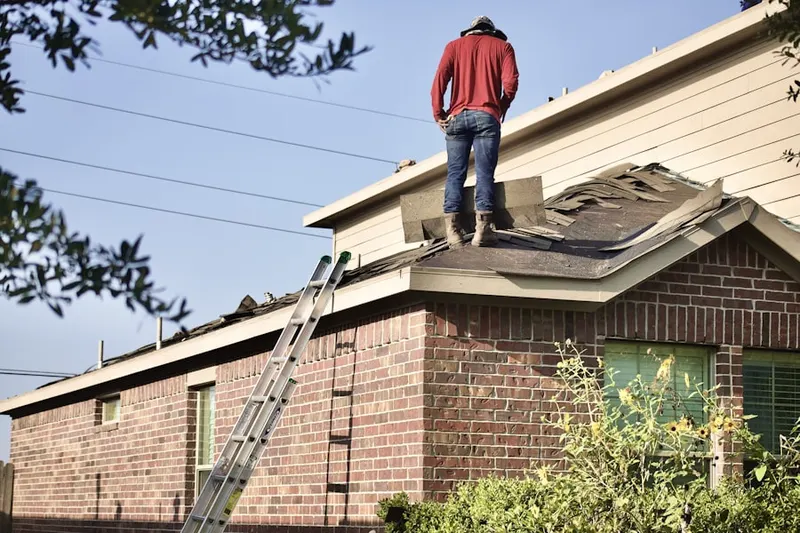 Professional roofer working on a residential roof in East San Pedro